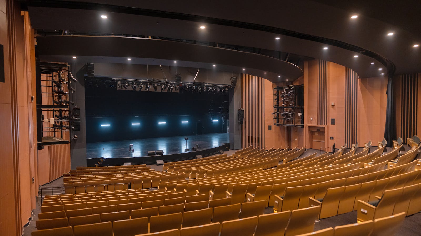 A conference organizer reviewing a stage layout with a colleague before doors open