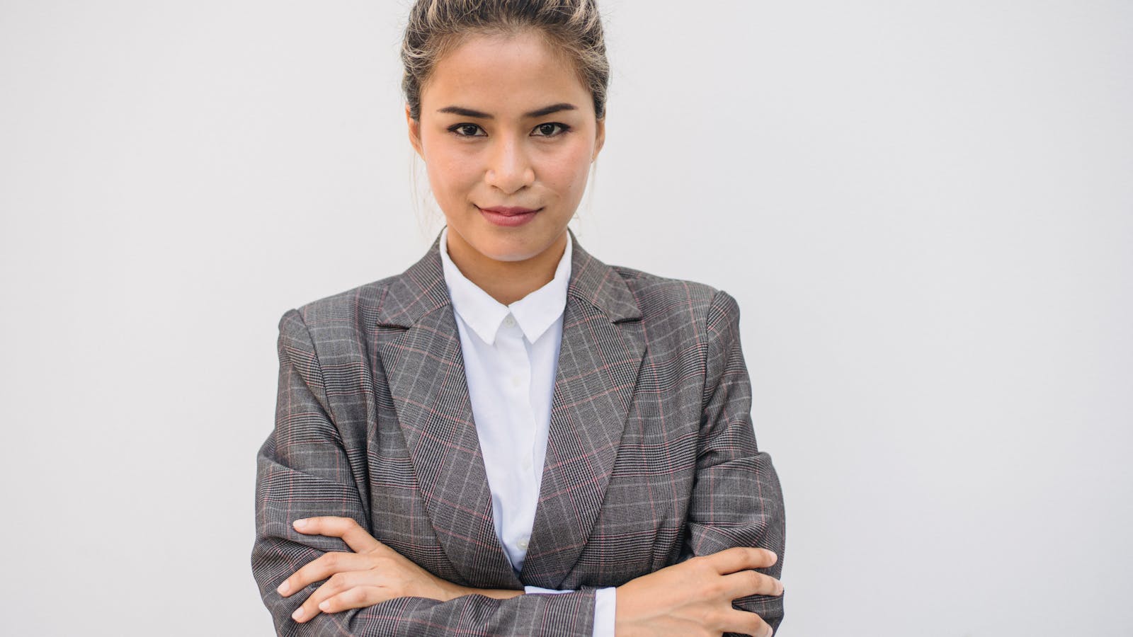 An executive in business attire reviewing roles on a laptop, focused and calm